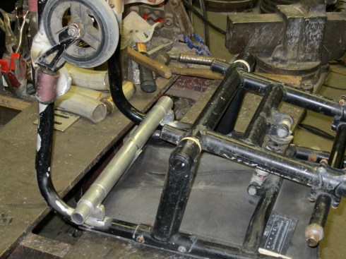 Picture showing the welds that attach the T shaped aluminum rod to the chair. This free hanging T shaped rod feeds into the upper tube of the cut-up bicycle frame. The T-rod can be removed, leaving just the 2 2in tube sections welded to the chair.