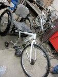 This picture shows the free hanging T-rod attached to the chair via the 2 2in tube sections that are welded to the chair. The T-rod is also feeding into the top tube of the bicycle frame creating the first of the three hand cycle attachment points.