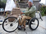 Front of wheelchair propped up on old bicycle seat, finding correct angle for attaching the hand cycle.