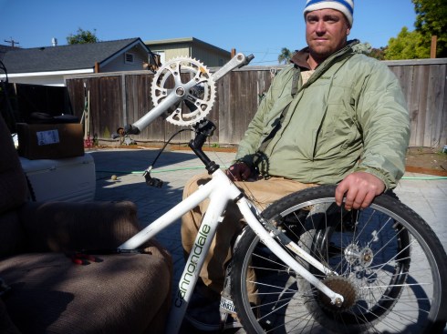 Recycled mountain bike with crankshaft replacing handle bars and rear wheel fitted into front fork.
