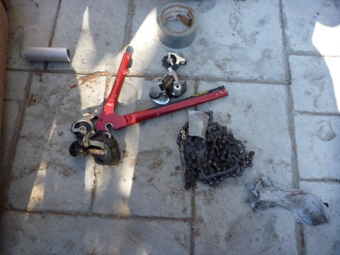 De-railer and 2 chains salvaged from donor bicycle. Two chains were combined into one long chain. De-railer was re-adjusted once attached to the front bicycle fork, allowing for shifting through all 7 gears.