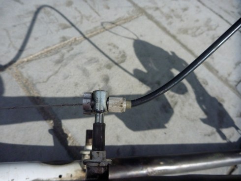 Original front brake bracket used to hold shifter cable.