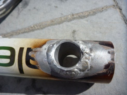 Aluminum housing tube welded inside the bottom tube of a canondale mountain bike frame.