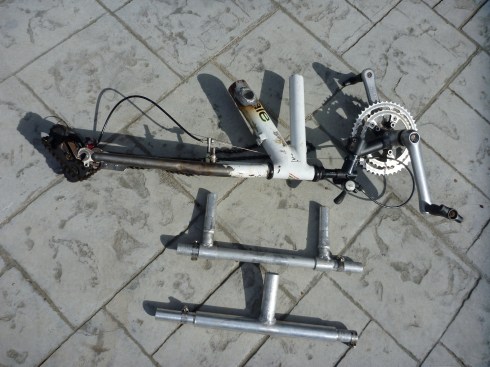 All the necessary attachable pieces of the Hand Cycle, minus the wheel.