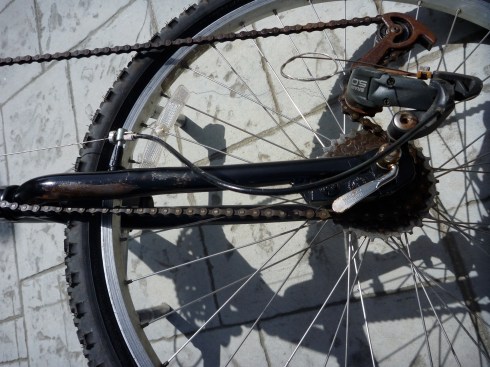 Lower end assembly to date. Notice alignment and attachment of de-railer, also de-railer shifting cable being fed through original front brake lines. So far I have needed a front brake. The front wheel spins freely. One hand on the pedal crank and the other on a rear chair wheel hand rail brings the unit to a nice controlled stop.